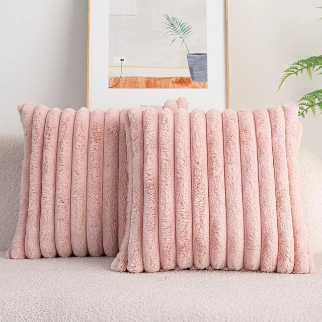 Pluche kussenhoezen in warme tinten op sofa